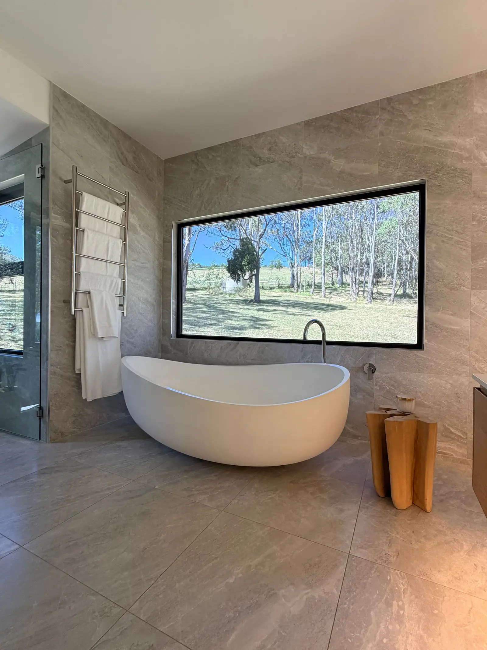 A stone bath beneath a window onto the paddock