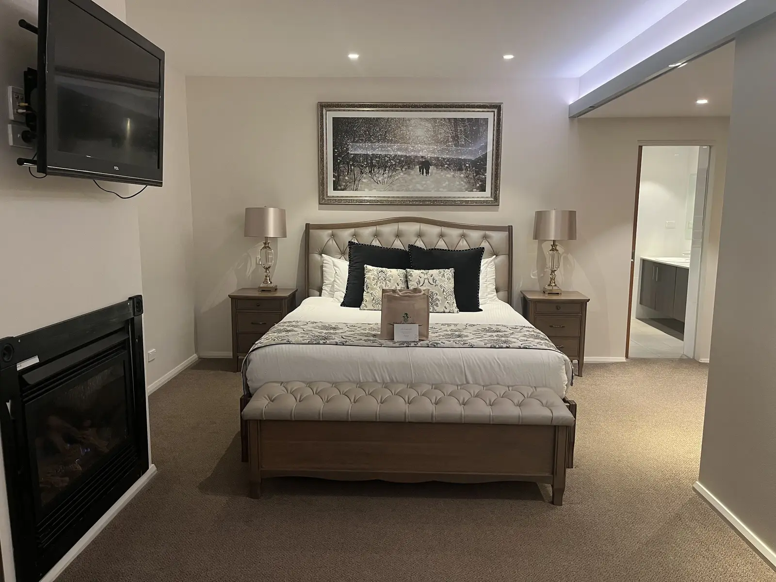 Warm king bedroom with tufted headboard and a fireplace at Eagle View Escape